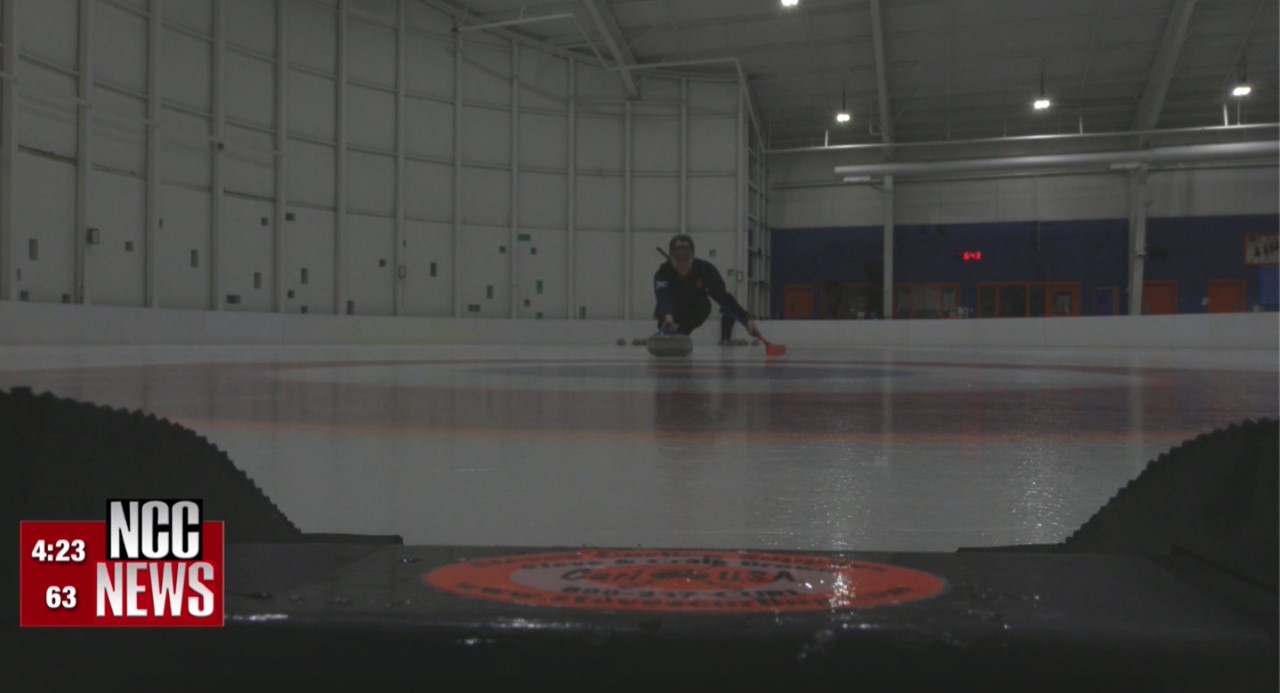 Senior Eric Silfies slides his stone towards the target.