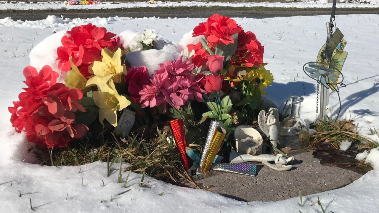 Flowers surrounding a tombstone at the Onondaga County Veterans Cemetery.