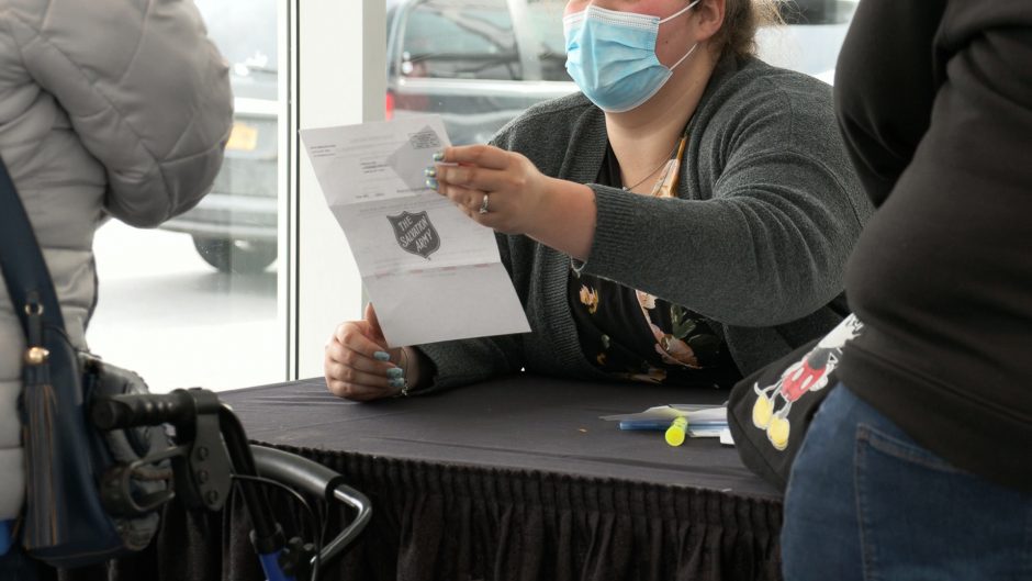 A woman handles a form provided by a registrant.