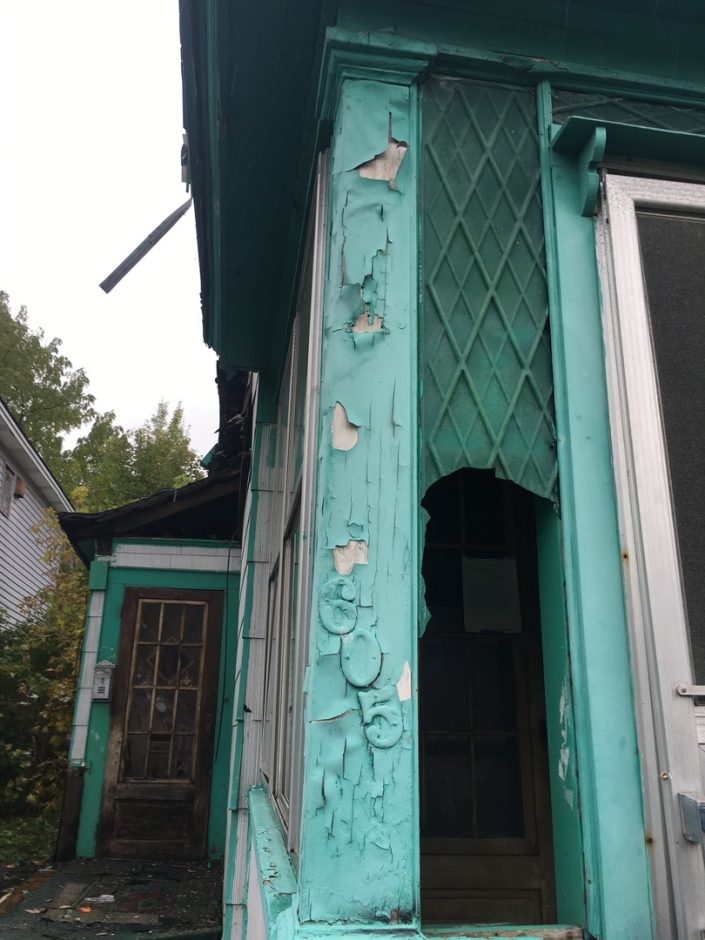 Peeling paint on the porch of a Syracuse home