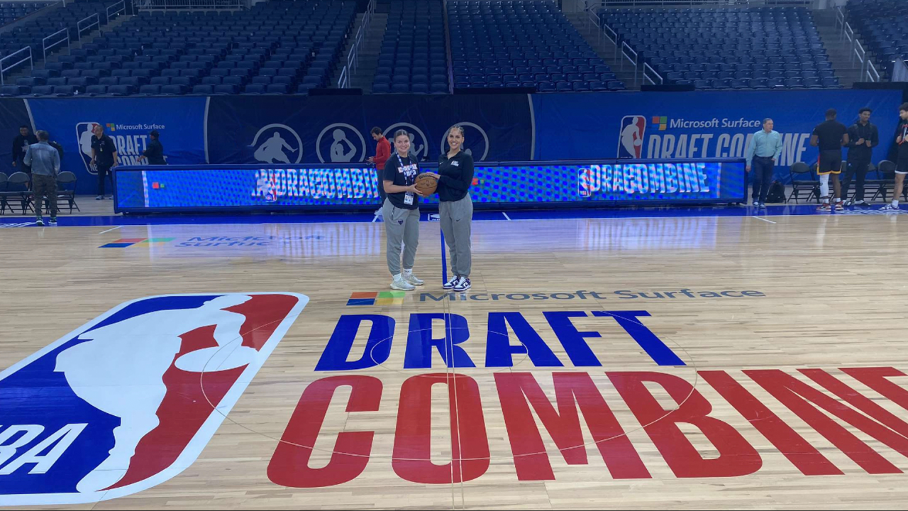 Kalia Butler and friend stand on NBA basketball court