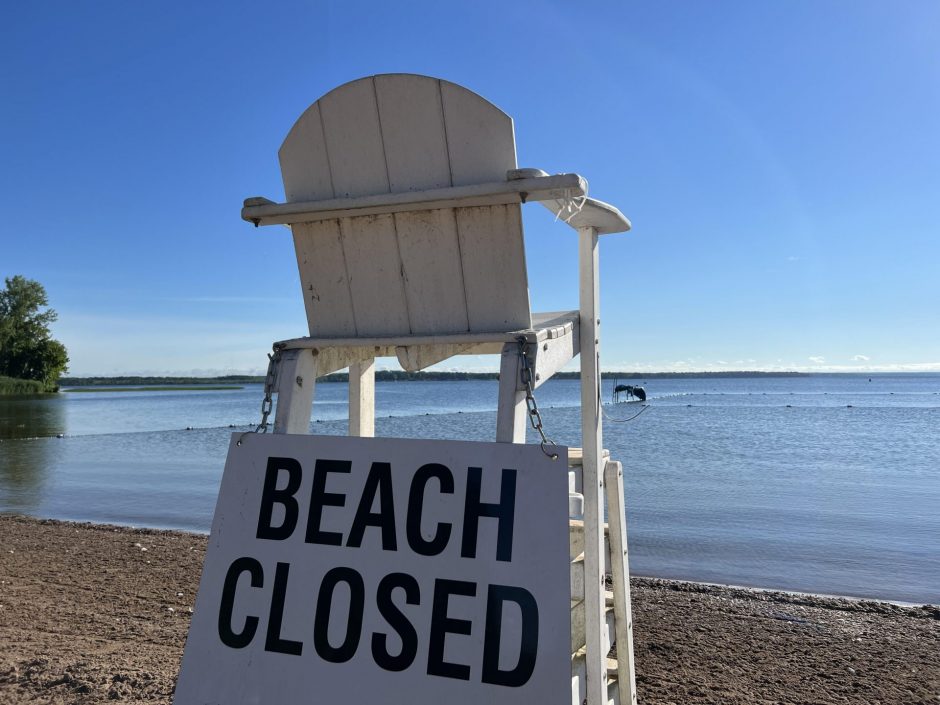 white life guard chair with "beach closed" sign