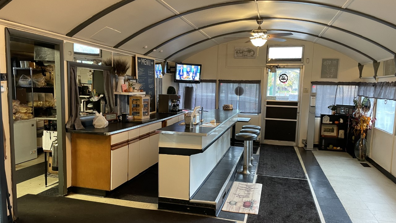 October 28, 2021 / Syracuse, NY - The quaint inside of the Across the Hall Café diner car in downtown Syracuse. The café features available seating for 19 customers with a television above the coffee counter.