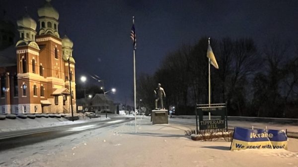 The flags of the United States and Ukraine fly side by side in front of St. John the Baptist Ukrainian Catholic Church in Syracuse.